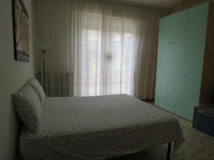 a bedroom with a bed in front of a window at La Baia di Lori in Pesaro