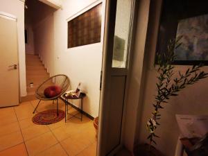 a hallway with a chair and a stair case at Vila Branka in Čanj