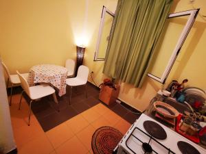 a kitchen with a table and a table and chairs at Vila Branka in Čanj