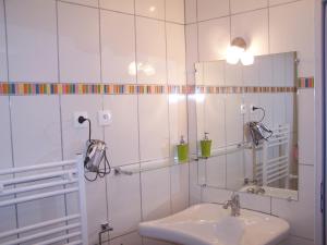 a white bathroom with a sink and a mirror at Aux 4 Saisons in Tabre +49 photos