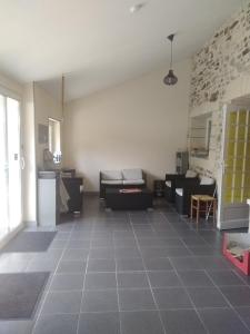 a living room with a couch and a table at Gite équestre en Normandie Haras de Sainte Colombe in Sainte-Colombe