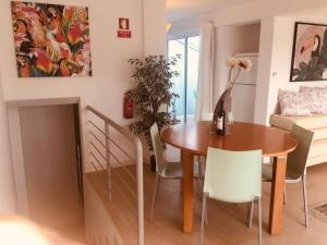 a dining room and living room with a table and chairs at Golden Club Hotel Resort Penthouse Free boat to Beach, CABANAS, Holiday in Cabanas de Tavira