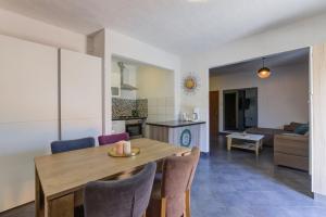 a kitchen and living room with a wooden table and chairs at Apartments Kristijan in Senj