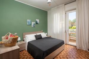 Posteľ alebo postele v izbe v ubytovaní Appartamenti Villa Miramare