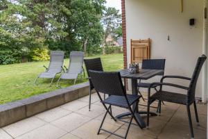 a group of chairs and a table on a patio at Villa Anna ll App 73 in Sankt Peter-Ording