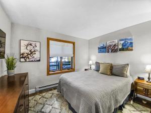a bedroom with a bed and a desk and a window at Inner Circle 3 Condo in Breckenridge +25 photos