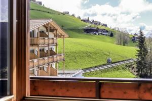 a view from a window of a building with a green hill at SCHUPFE- direkt neben der Kabinenbahn Gitschberg Jochtal in Maranza