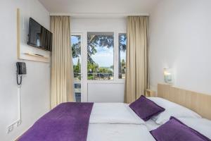 Postel nebo postele na pokoji v ubytování Hotel Slaven