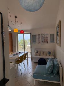 a living room with a couch and a table at Casa vacanze La Balena2 in Capo dʼOrlando