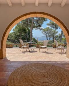 a patio with chairs and a table with a view at Villa Dora (Only adults) in Jávea