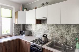 Kuchyňa alebo kuchynka v ubytovaní Quadratum Apartment by Noclegi Renters