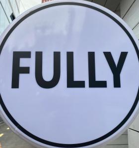 a sign for the fyi tv company at Fully Mini Hotel in Seoul