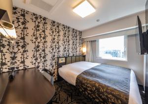 Cama ou camas em um quarto em APA Hotel Hakataeki Chikushiguchi