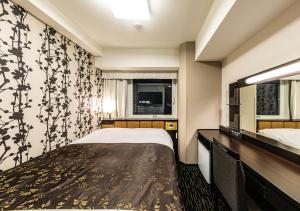 Cama ou camas em um quarto em APA Hotel Hakataeki Chikushiguchi