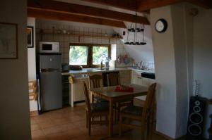 a kitchen with a table and chairs and a clock at Boddenkieker in Born