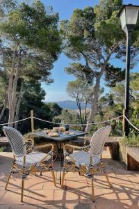 two chairs and a table on a patio with a view at Villa Dora (Only adults) in Jávea