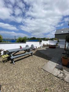 a picnic table sitting next to a body of water at Beautiful Central 3-Bed House in Co Clare in Milltown Malbay