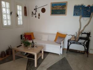 Olive Grove Soulis Family Estate في بورتوخيلي: غرفة معيشة مع أريكة بيضاء وطاولة