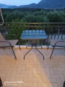 a table and chairs on a balcony with a view at CHRYSPY Toulatos Studios in Pouláta