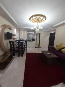 a living room with a couch and a dining room at Borg Barka - Families Only in Alexandria