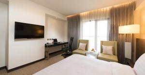 מיטה או מיטות בחדר ב-Forte Hotel Changhua