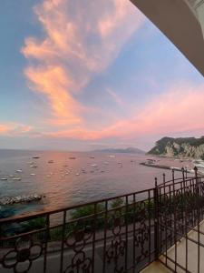 a view of a large body of water with boats at Casa di charme panoramica a Capri sulla spiaggia. in Capri