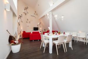 a dining room with a white table and white chairs at Avenue Apartments in Prague