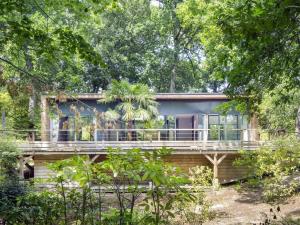 a house with a wrap around deck in the woods at Oasis in Arcachon