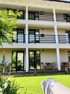 a white building with windows and a lawn at Ido in Mamaia Nord +16 photos