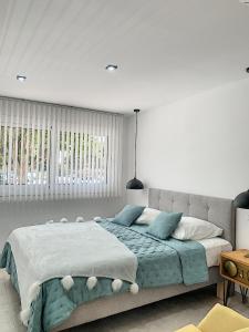 a bedroom with a large bed with blue pillows at Smp BLING BLING in Toulon