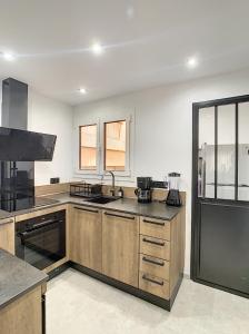 a large kitchen with wooden cabinets and a sink at Smp BLING BLING in Toulon +5 photos
