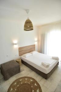 a bedroom with a large bed and a large window at Haus Risos Next Generation in Toroni