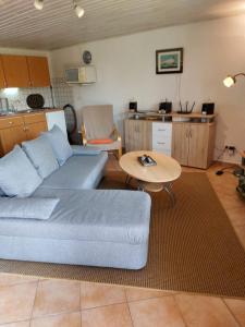 a living room with a couch and a table at Boddenbrise in Born +5 photos