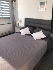 a bedroom with a large bed with two white pillows at Domaine Trevinella in Cauro