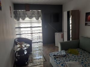 a living room with a couch and a table and a window at Luxuries Beta in Saturn