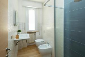 a bathroom with a toilet and a sink and a shower at Appartamenti Villa Miramare in Rimini