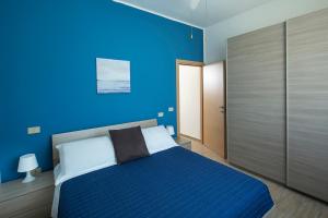 Posteľ alebo postele v izbe v ubytovaní Appartamenti Villa Miramare