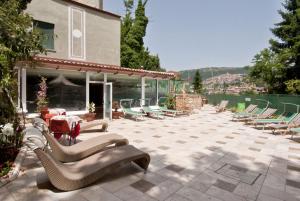 a patio with chairs and a table and a building at Hotel Argentina & SPA in Fiuggi