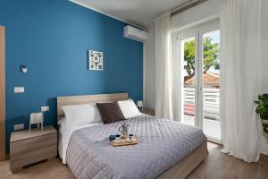 Posteľ alebo postele v izbe v ubytovaní Appartamenti Villa Miramare