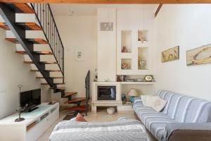 ein Wohnzimmer mit einer Couch und einer Treppe in der Unterkunft Casa Carlotta in Rimini