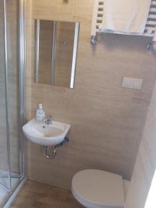 a bathroom with a toilet and a sink at OperaHostel in Bydgoszcz