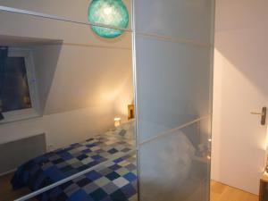 a bedroom with a bed and a glass wall at StudioLille - Alexandre in Lille