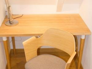 a wooden desk with a chair next to a wooden table at StudioLille - Alexandre in Lille +1 photo