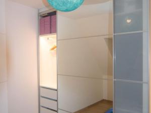 a closet with a glass door and a refrigerator at StudioLille - Alexandre in Lille