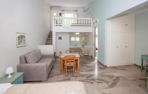 a living room with a couch and a table at Lido Apartments Tolo in Tolo