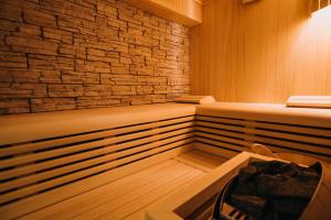 a sauna with a stone wall and two beds at Villa Allure of Dubrovnik in Dubrovnik