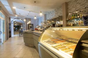 a bakery filled with lots of doughnuts and pastries at Hotel Club Eloro in Noto Marina