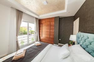 a bedroom with a large bed and a large window at Apartments Cukovic in Herceg-Novi +44 photos