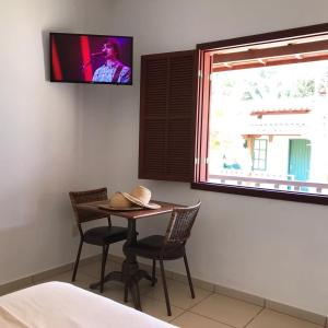 En tv och/eller ett underhållningssystem på Pousada Vila Cocais