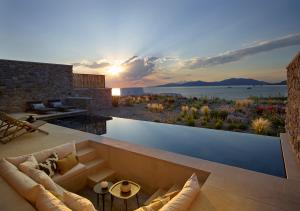 a living room with a view of the ocean at Bonzoe Suites & Villas in Mýkonos City